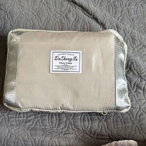 Xin Zheng Tu Travel Pouch in Beige with Silver Trim